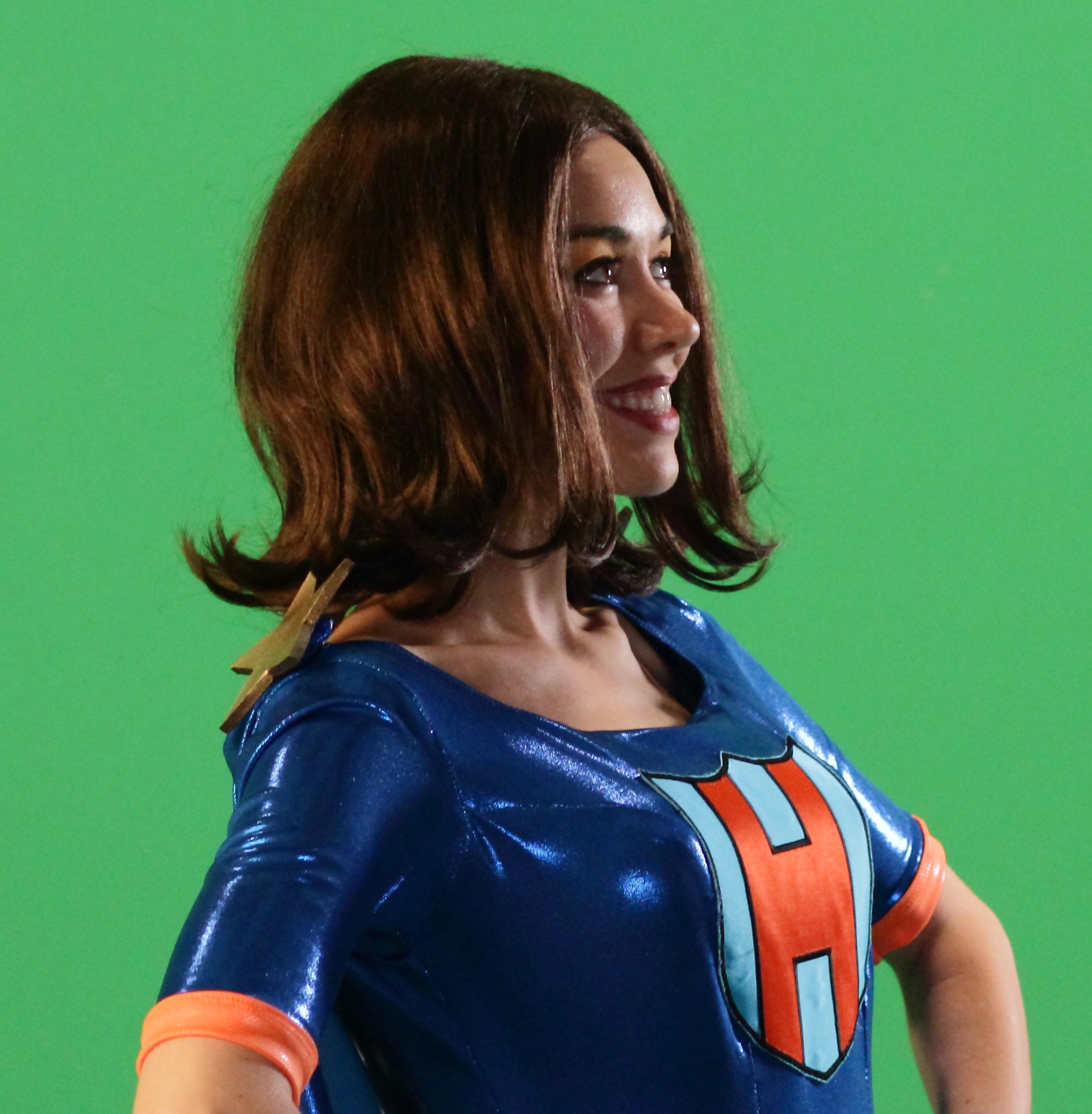 Tara as Hero Lass from Shelf Life in a green screen effects shot.
