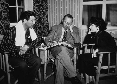 Elizabeth Taylor, director Victor Saville and Robert Taylor going over the script of 