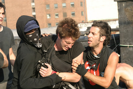 Tina (ROSARIO DAWSON) left and Cody (BRETT BERG) right, help Jake (NATHAN CROOKER) after he is beat down in THIS REVOLUTION.