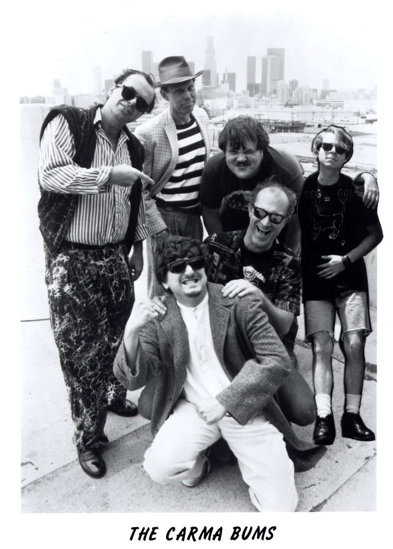 The Carma Bums 1992 Twisted Tour of Words. Standing (L-R) Doug Knott, Mike M. Mollett, Scott Wannberg, Robert (Bobbo) Staron. Kneeling (L-R) Michael Bruner, S.A. Griffin.