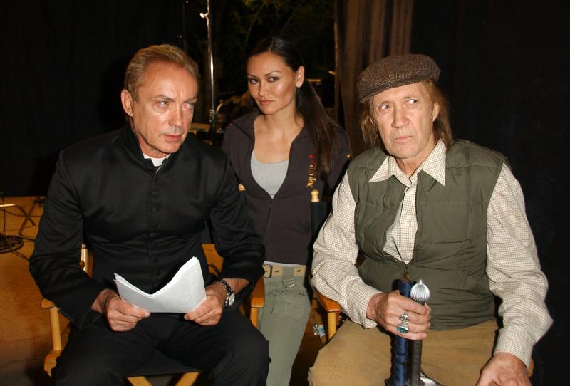 Udo Kier as Father Paul, Mary Christina Brown as Japoniko, and David Carradine as the Shopkeeper in 