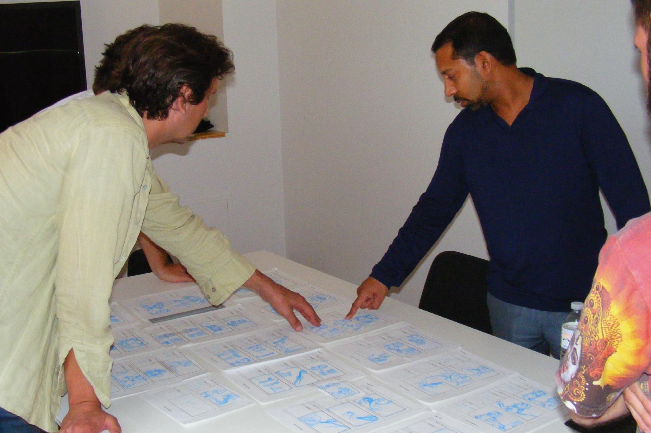 Stephen Lategan reviews storyboards for a television project (2013)