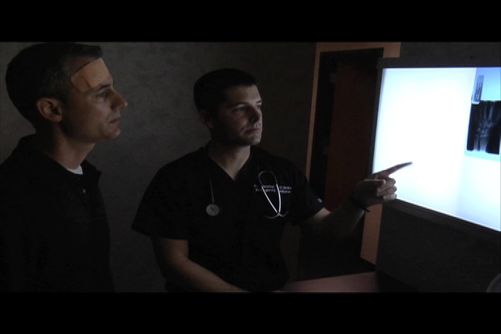 Dr. Rich goes over an x-ray with a patient.