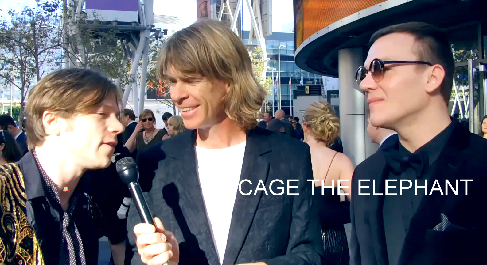 Gregory Graham aka Heavy Metal Greg interviewing Matthew Shultz and Brad Shultz of Cage the Elephant at the 2015 Grammy Awards.