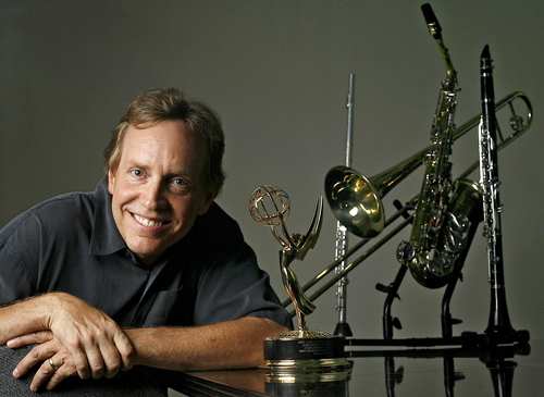 Larry Newman with his Emmy and collection of musical instruments.