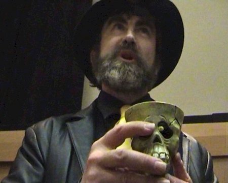 Davro the Criminal Mastermind Played by Scott Johnson holding a scull cup.
