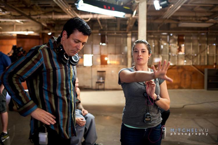 Sara Geralds talking over shots with director Daniel Chavez on the set of 