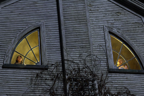 Chelsea Lutz (CHLOE MORETZ, right) and Jodi (ISABEL CONNER) look through the eyes of the house in THE AMITYVILLE HORROR.