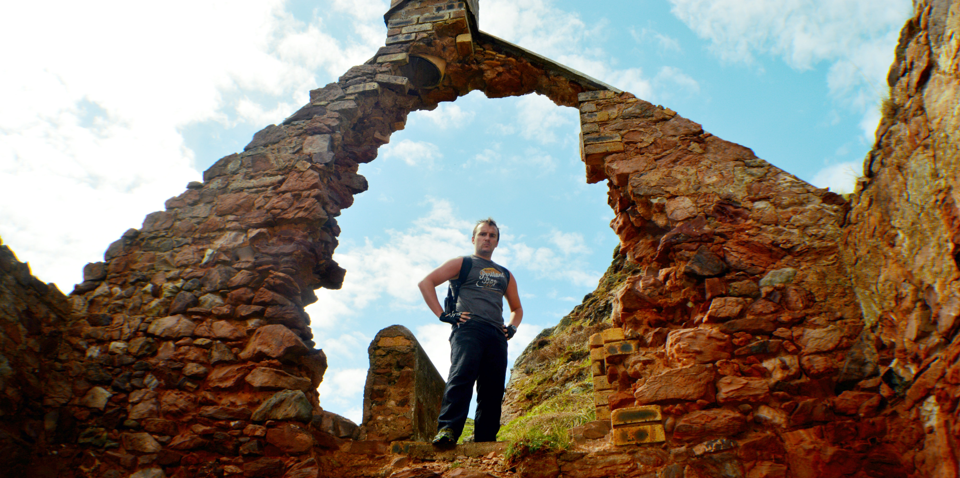 Shawn stands in the arch of the dilapidated smuggler's bothy.