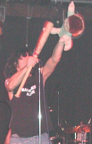 As Joey Alive (a.k.a. Joey Ramone), beating on the brat with a baseball bat during Ramones Alive performance, Salt Lake City.