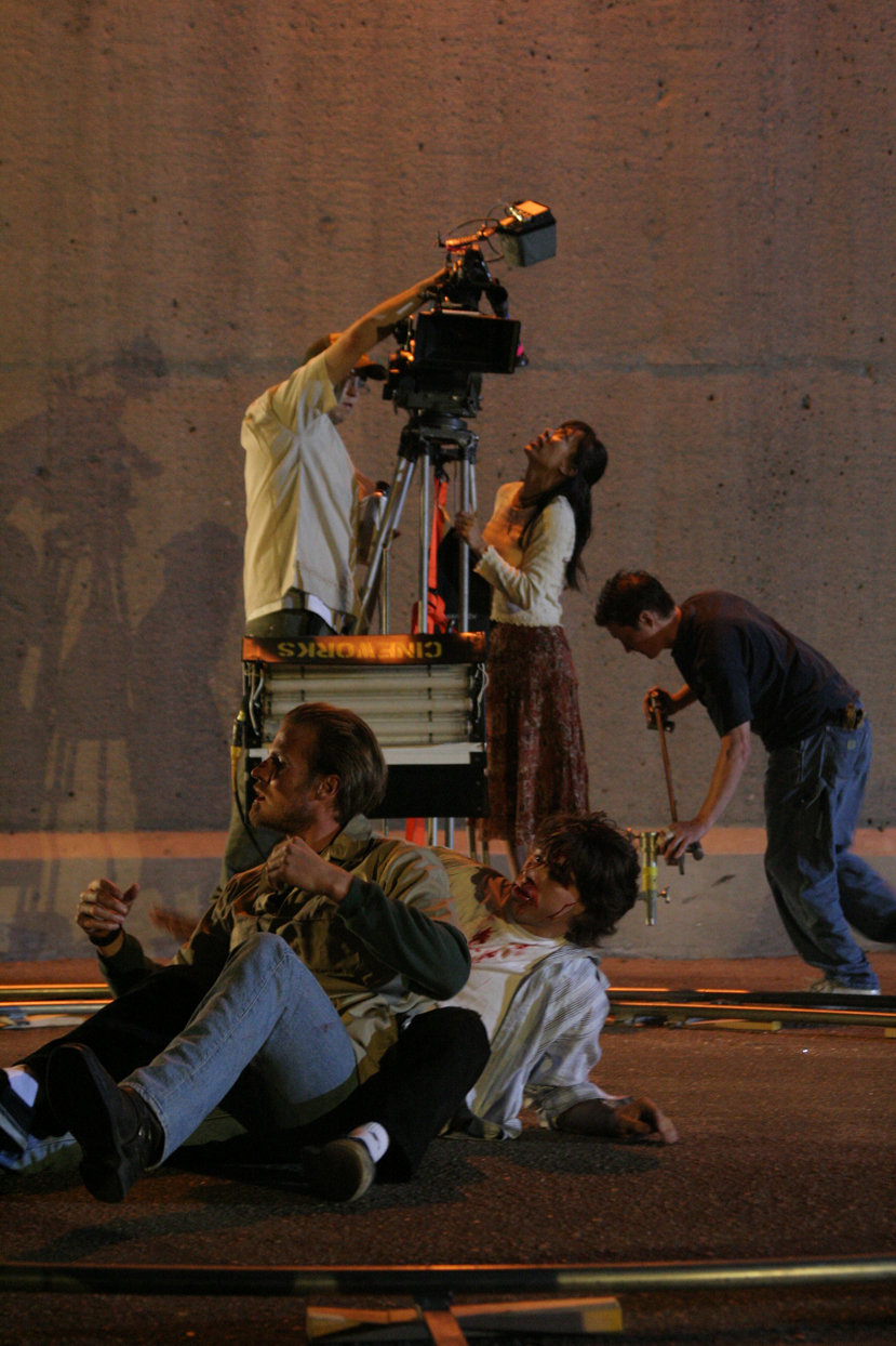 D. Lee Inosanto directing a dolly shot as actors Mark McGraw and Mike OLaskey rehearse a fight scene on the set of THE SENSEI.
