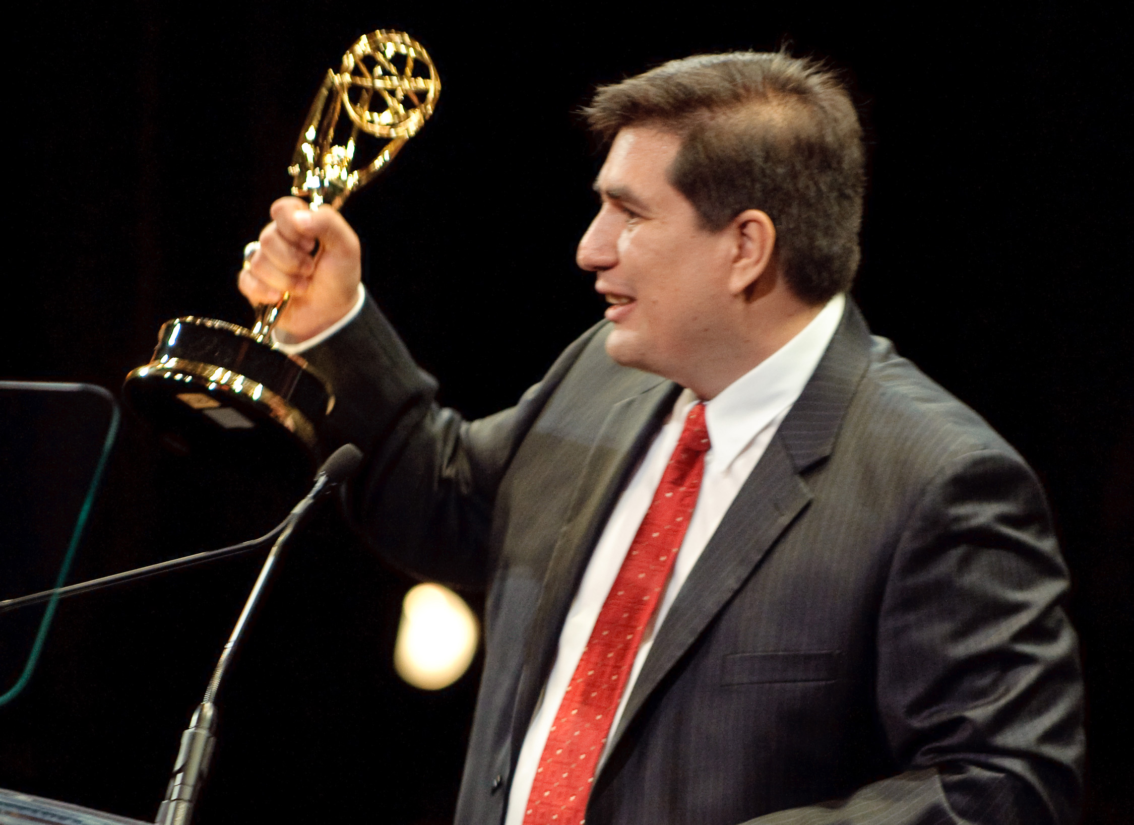 Ricardo Andrade receiving 12th Emmy At 30th News and Documentary Emmy Awards for the Art Direction and Graphic Design of PBS's Illicit: The dark trade.