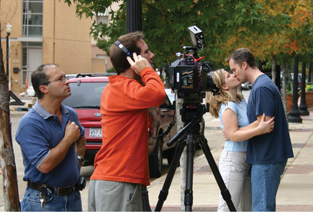 Bachelor 37 Director Jay Gormley (wearing headphones) and cinematographer John Papa review a shot of John Venable and Tammy Skinner.