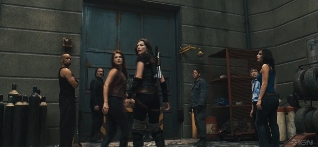 Norman Yeung as Kim Yong, with Boris Kodjoe, Kim Coates, Ali Larter, Milla Jovovich, Wentworth Miller, and Kacey Barnfield in RESIDENT EVIL: AFTERLIFE
