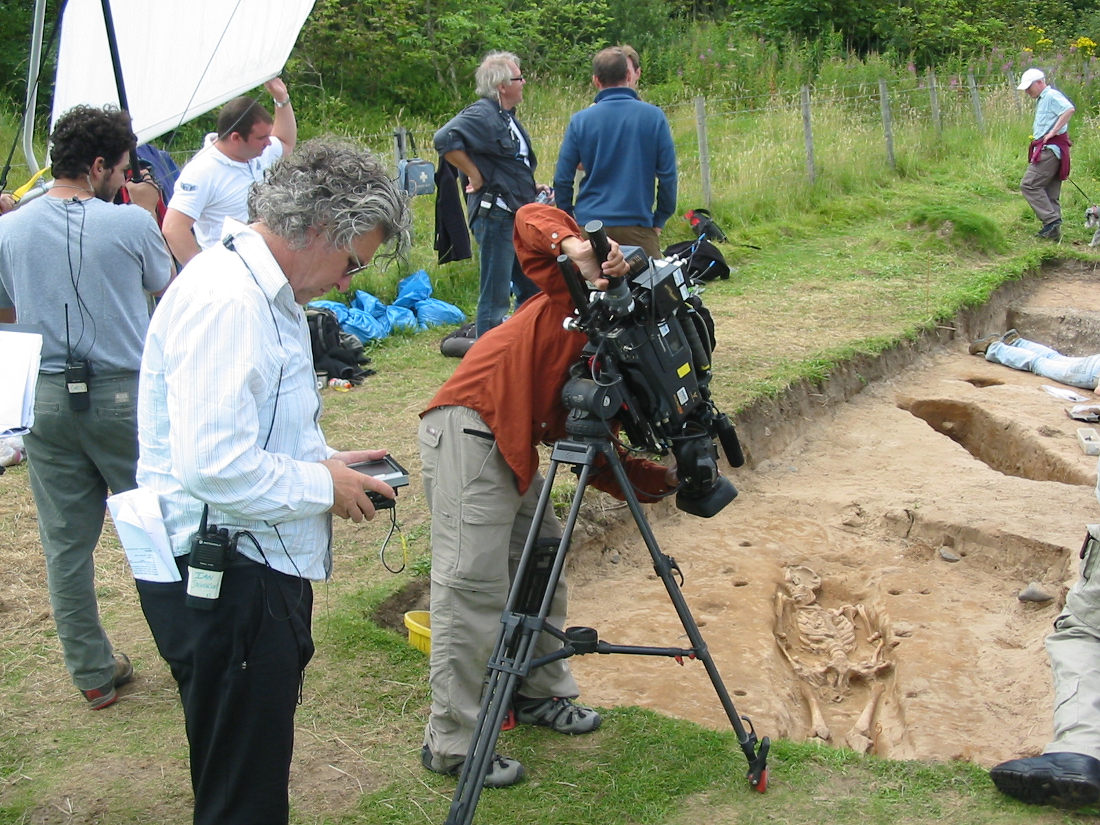 Australian TV director Ian Stevenson (foreground), directs The Discovery Channel's 'Bone Detectives', on location in northern England. Ancient mummy lies in grave. More at www.ianstevenson.tv