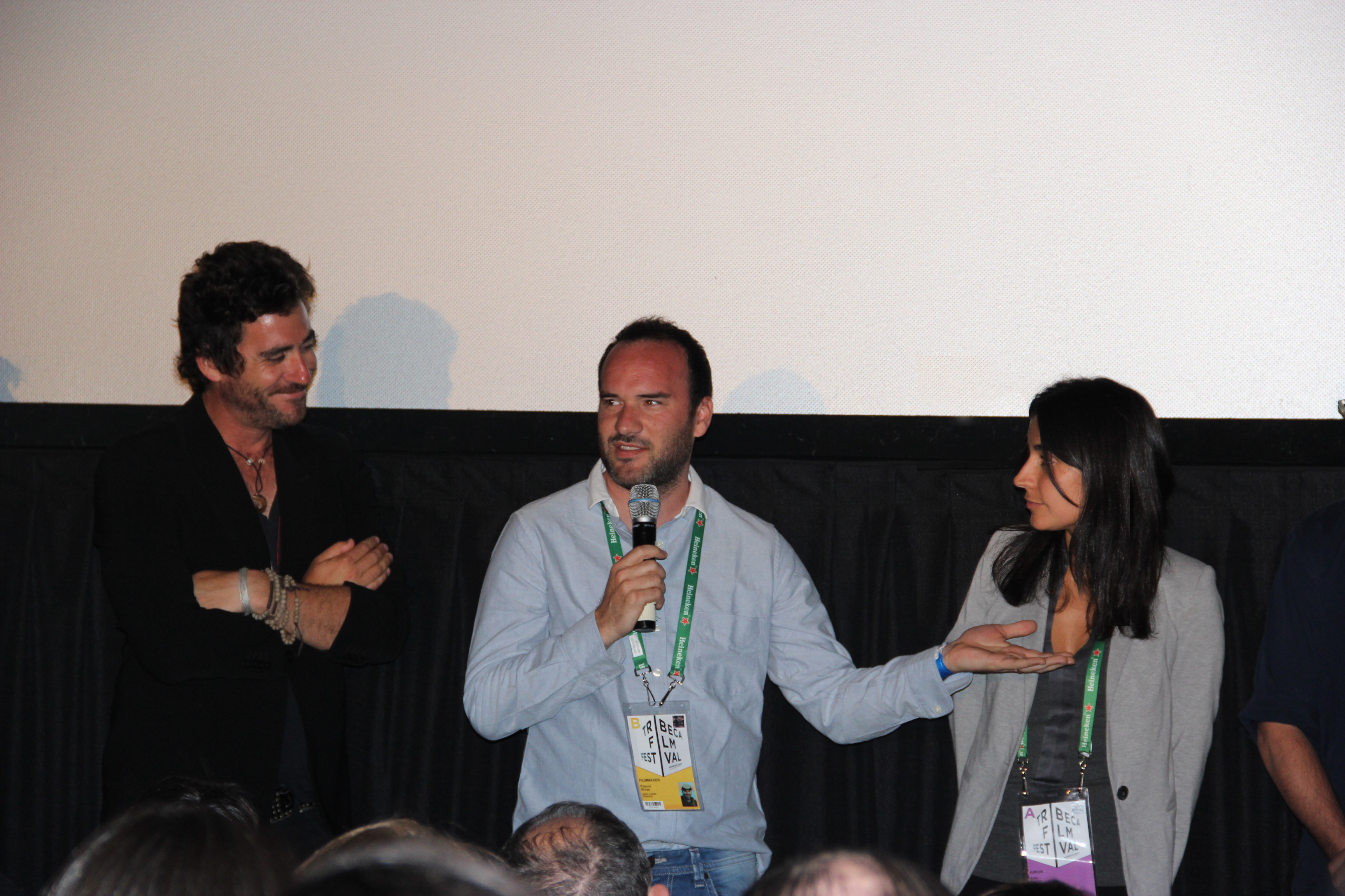 Directors Bryn Mooser (left), and Julia Bacha (right) listen as director Pascui Rivas (center) talks about 