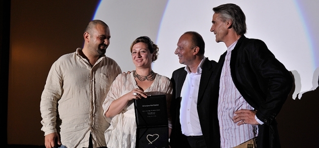 Filmmaker, producer and festival director Diana El Jeiroudi receives with her partner Orwa Nyrabia the Katrin Cartlidge Award at Sarajevo Film Festival 2012 presented by Festival director and Jeremy Irons.
