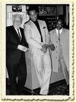 Colonel Barney Oldfield with George Foreman and Charles R. 