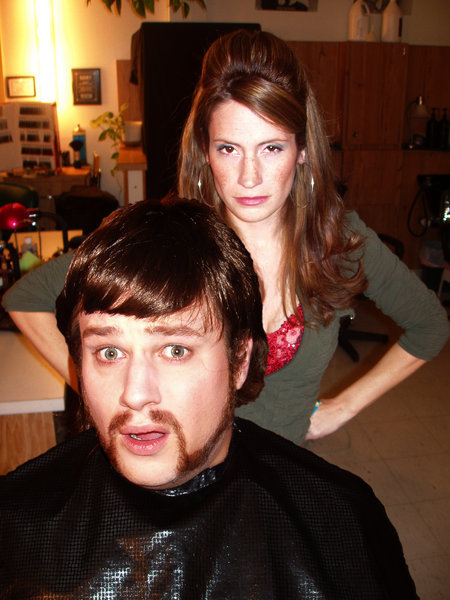 Tim (Max Bullis) questions the wisdom of getting a haircut from an angry stylist, Renee (Jennifer Pfalzgraff), in 