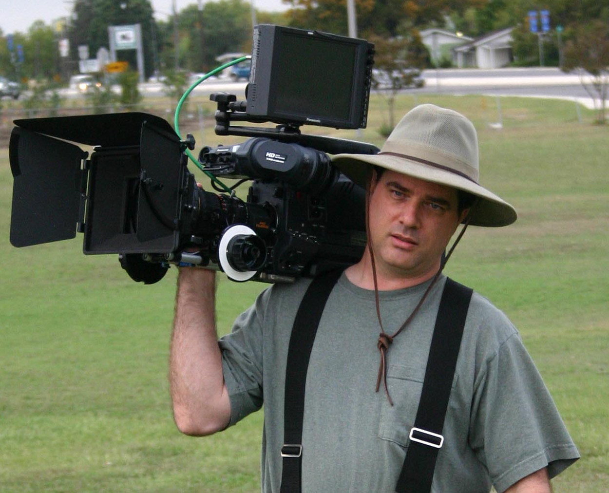 Michael Morlan carrying camera on the set of 