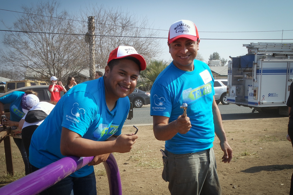 Omar Leyva and Ramiro Rodriguez, from McFarland USA, helping build a playground with McFarland Community.