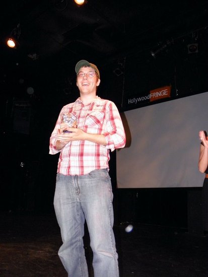 Aaron Kozak accepting LA Fringe Critic's Choice Award at the Hollywood Fringe Festival for 