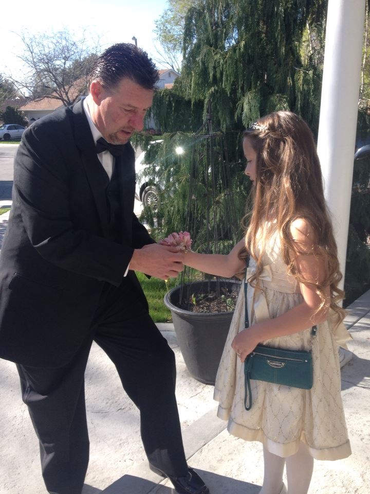 Malia getting her first flower, Father Daughter dance.