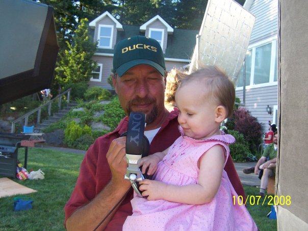 Rob and daughter Breven Holloway at the monitor on set. Breven wants to wear the headset.