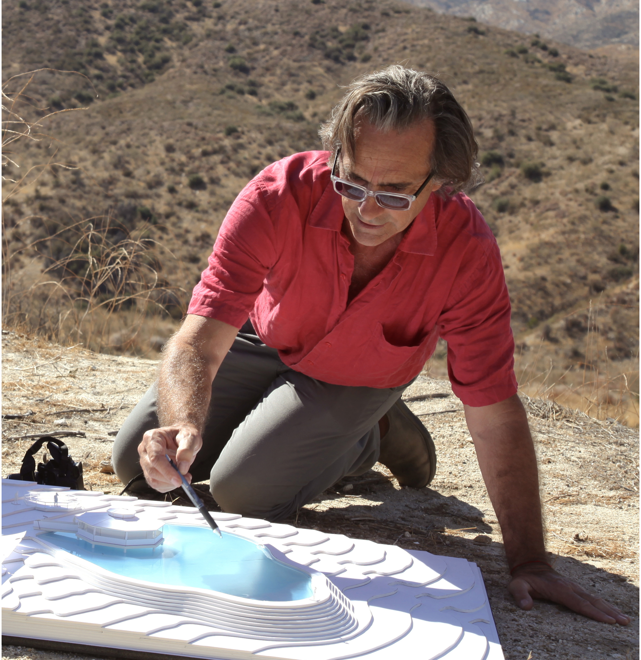 Toby Corbett with model of Lake and Ranch House for the film BROKEN HORSES