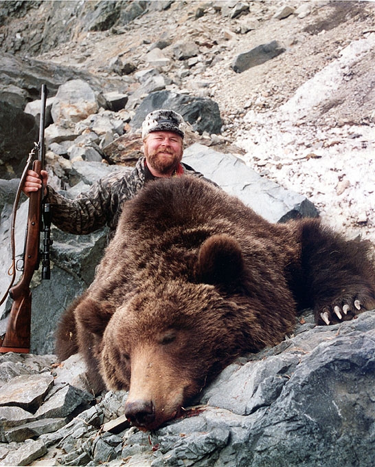 BUCK McNEELY with a Siberian Brown Bear he hunted in Russia