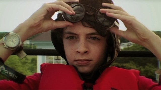 John Rebello as Warren Holiday, about to take off in a flying machine, June segment of Twelve, directed by Noah Lydiard, 2007. Filmed in Massachusetts.