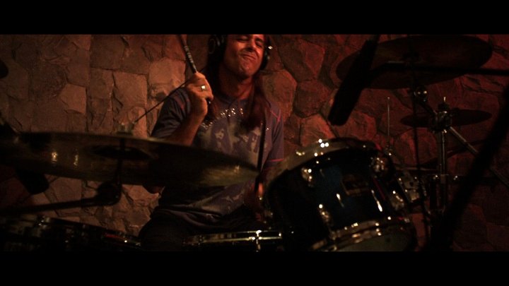 Actor Troy McFadden as rock star Tommy Ryan pounding the skins in the studio in the film 'Glory Days'