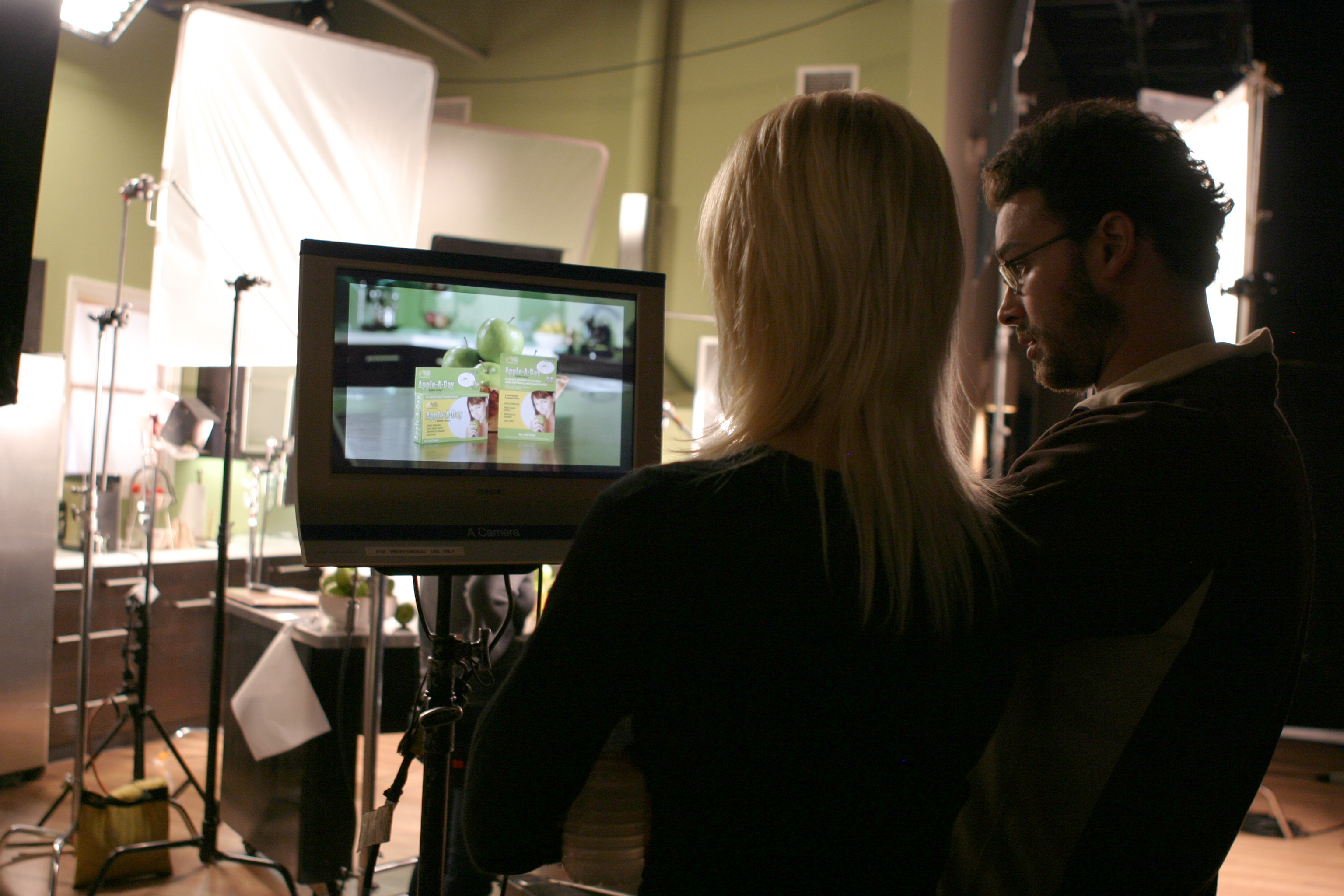 Director Jenine Mayring composes a shot with cinematographer Evin Grant, on the set of a national TV commercial shoot for Apple-A-Day Edible Strips, produced by Brooklyn Girl Productions.
