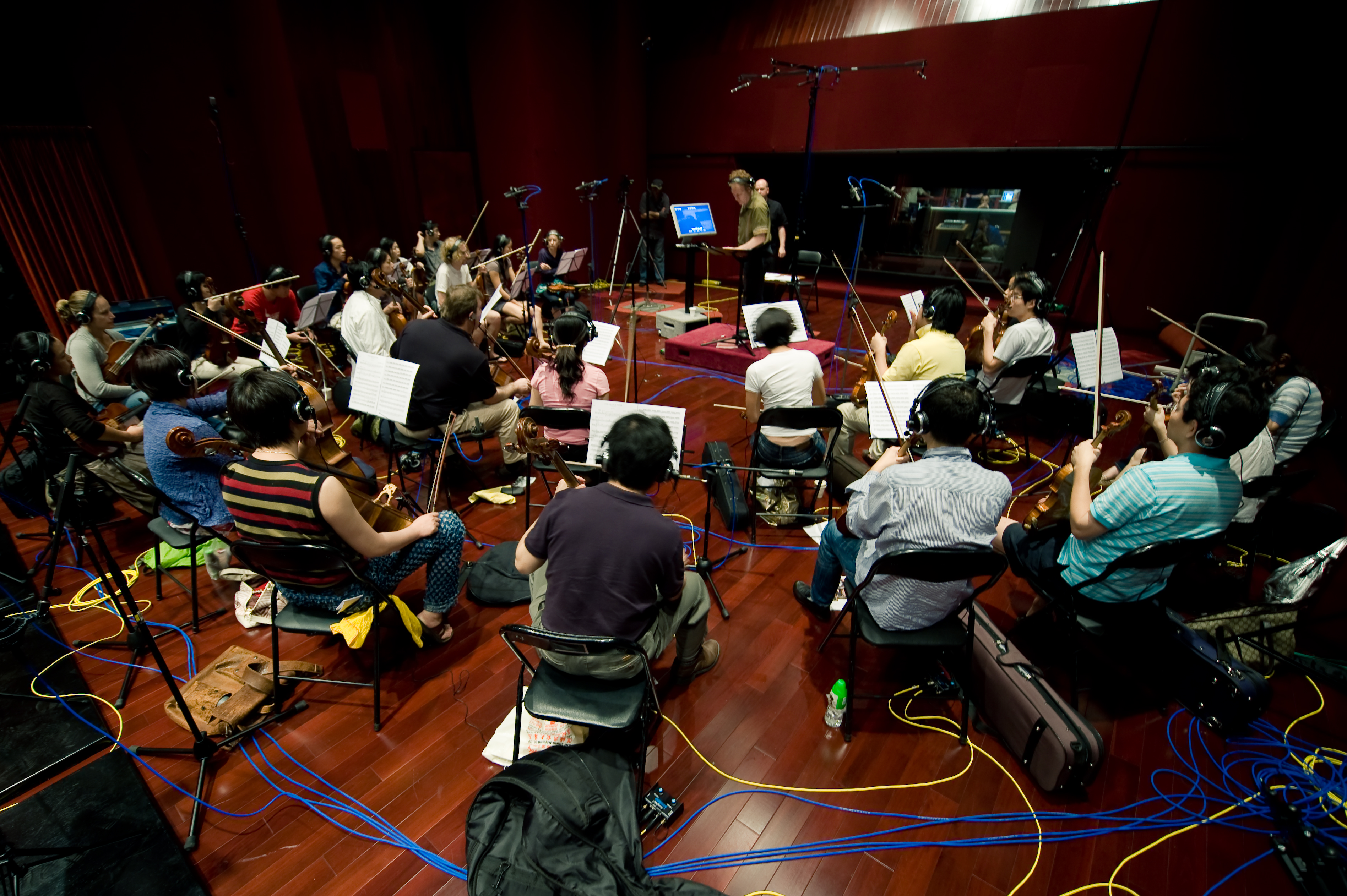 Conducting the score for The Orange Paper composed by Sascha Selke, performed by members of the Hong Kong Philharmonic Orchestra.