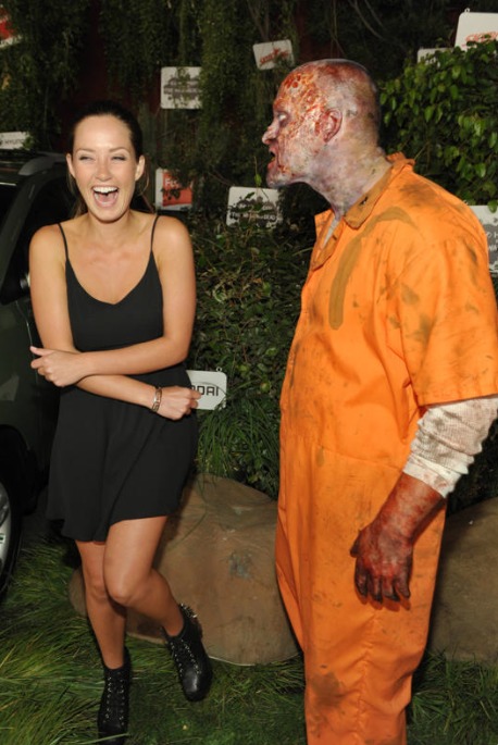 Merritt Patterson, left, and a walker attend Hyundai and Skybound's 'The Walking Dead' 10th Anniversary Celebration Event, on Friday, July 19, 2013 in San Diego, Calif.