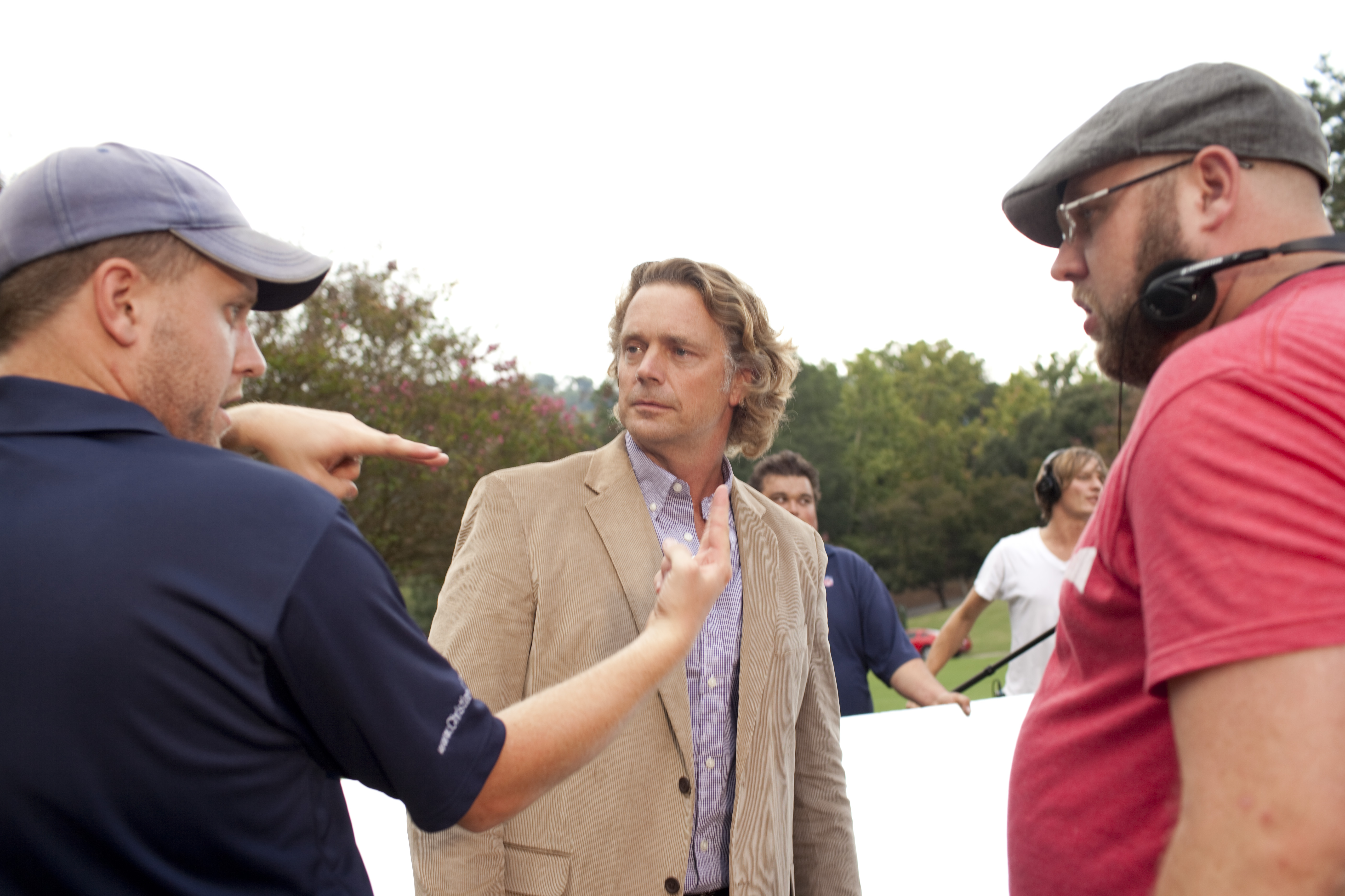The brothers talk with actor John Schneider on the set of October Baby