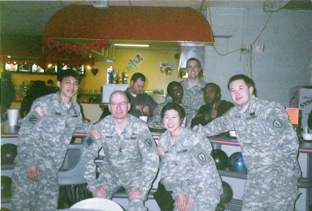 Lil Rhee with fellow cast members in a military training video