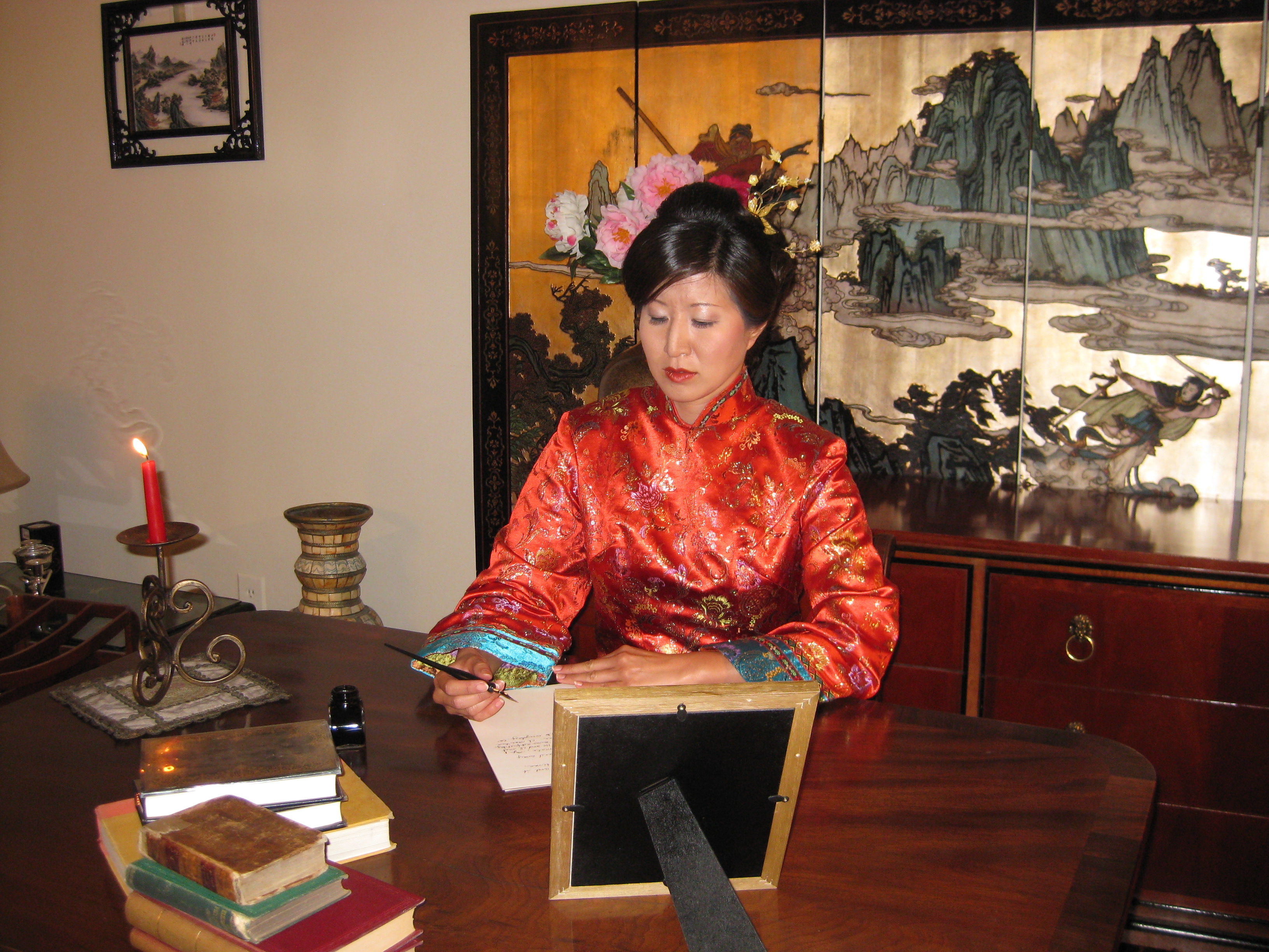 Lil Rhee as Princess Der Ling, writing at the desk
