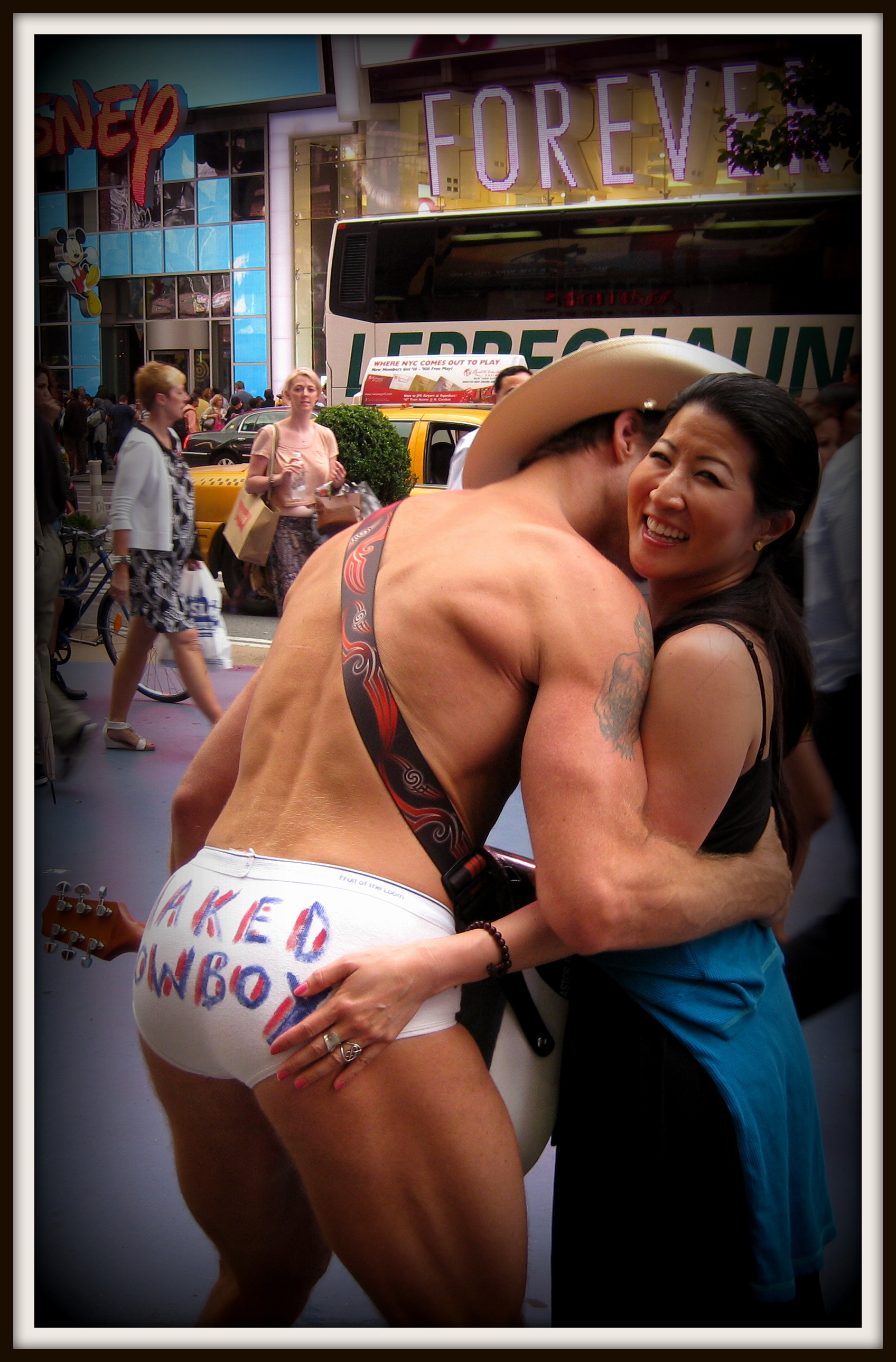 Lil Rhee with the Naked Cowboy, backside, in Times Square