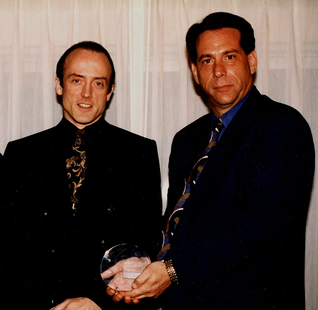 Receiving Manager Of The Year Award from United Artists Theatres President, Neal Pinsker, at ShoWest at Bally's Hotel in Las Vegas (March 1999).