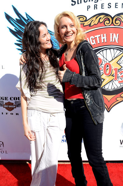 Cynthia Rose Hall shares a moment with a friend during red carpet arrivals for Strength in Support / Strength in Thunder annual celebrity motorcycle ride to benefit veterans.