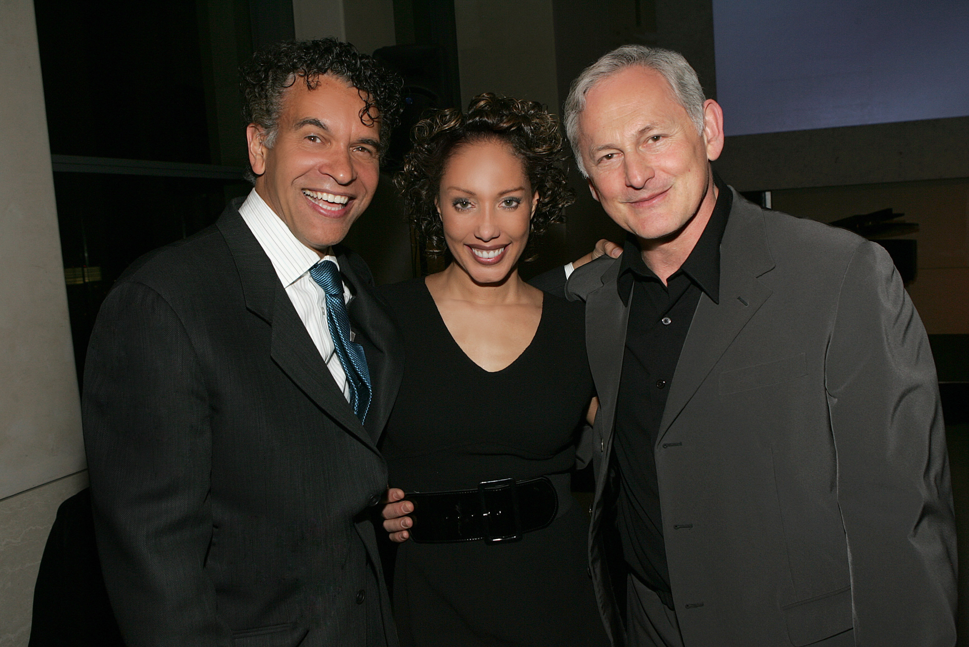 Joan Baker embraces (L) Brian Stokes Mitchell & (R) Victor Garber at the launch event 