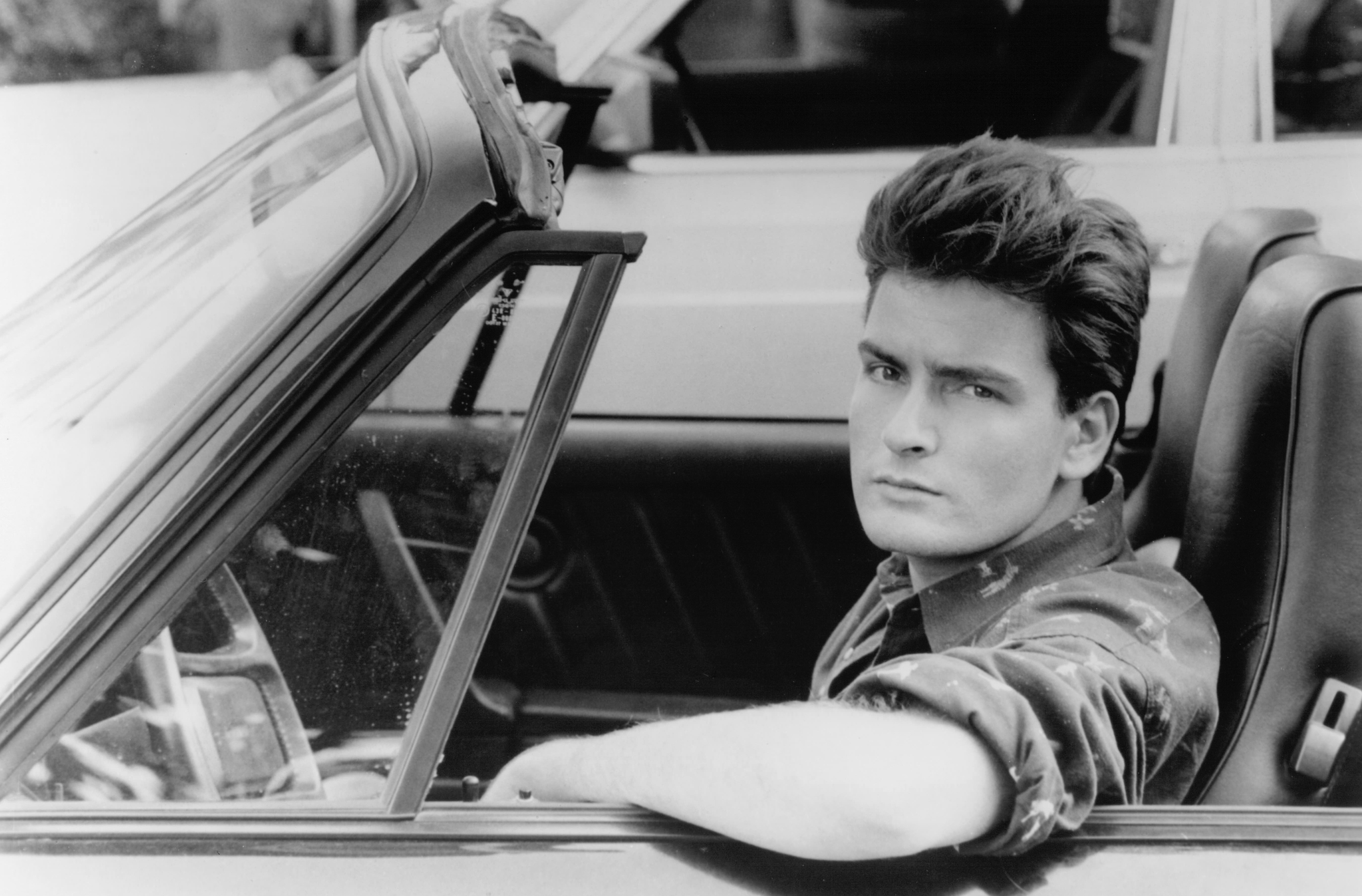 Still of Charlie Sheen in Three for the Road (1987)