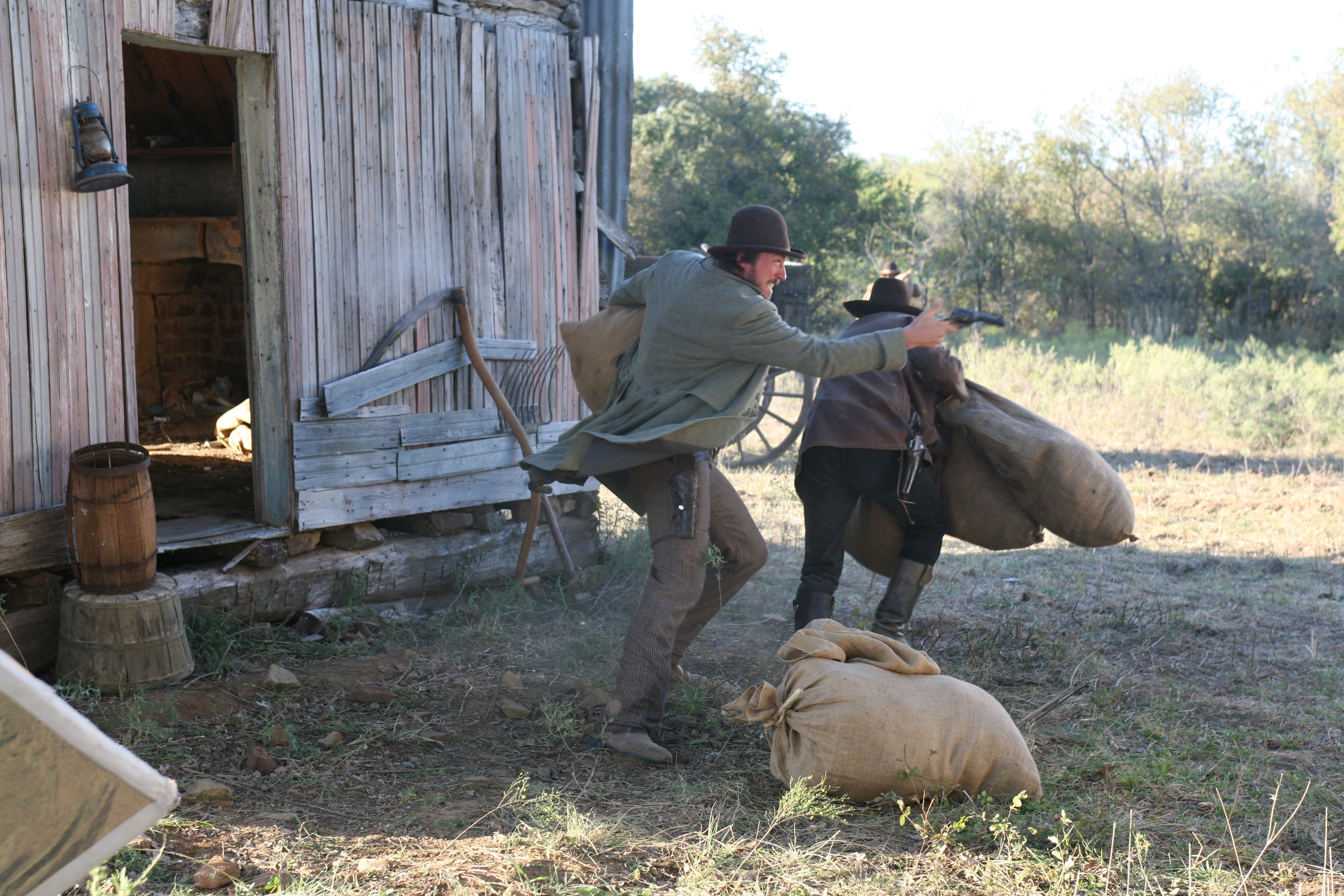James McKinnon (Tanner Beard) fires back as they flee the barn.