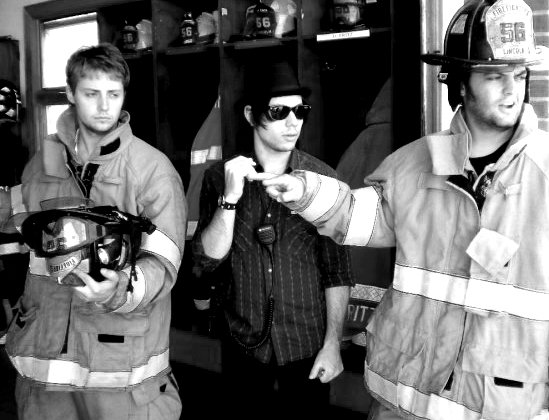 Dan Clifton and Bernard Hunt don firefighter gear as David Brooks attempts to gain control of the situation.