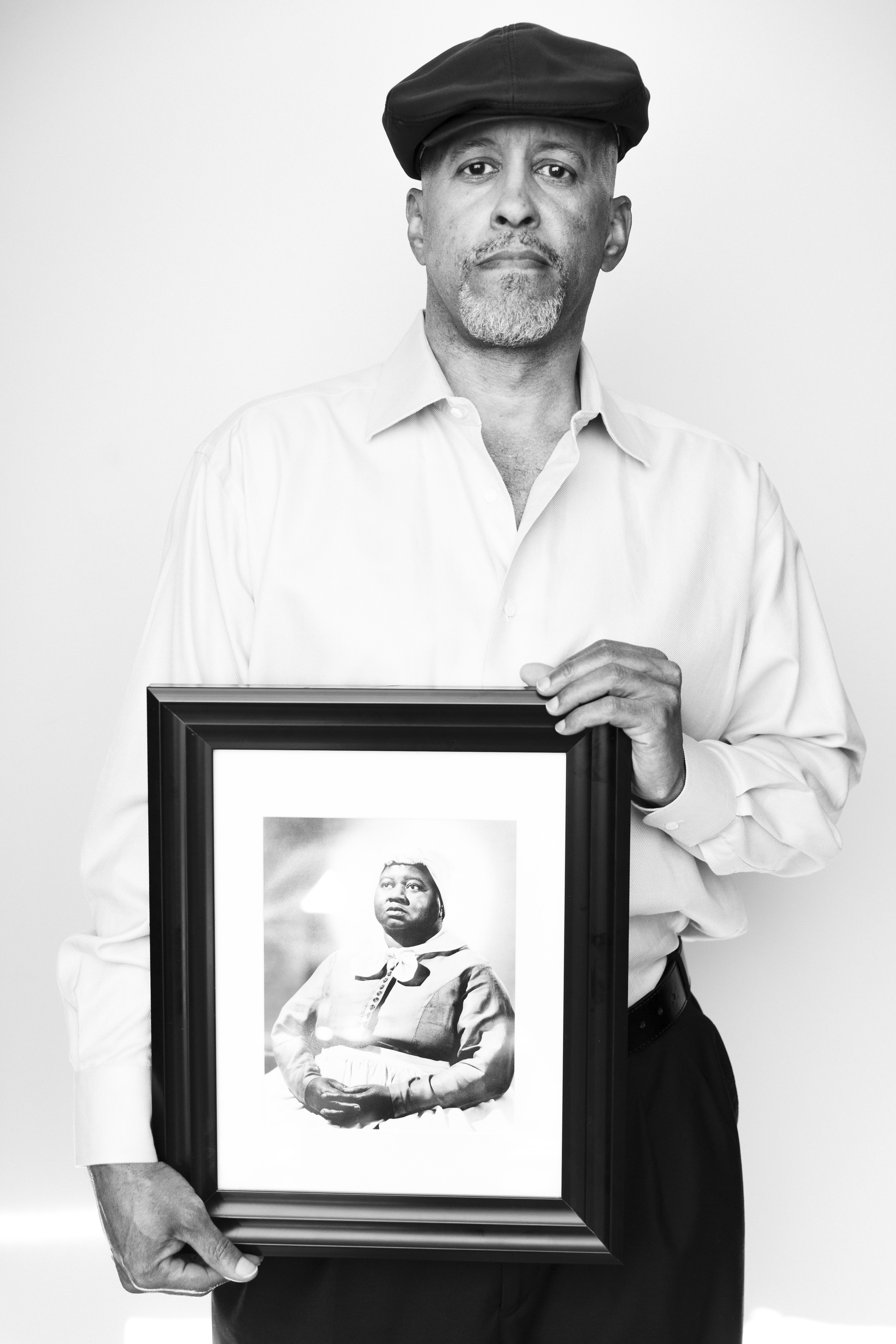 Kevin John Goff posing with his aunt's picture (Hattie McDaniel).