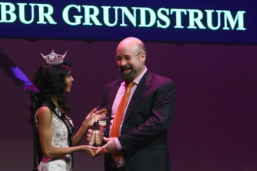 Bindhu Pamarthi presents Composer Brian Wilbur Grundstrom with the Outstanding Emerging Artist Award at the Mayor's Arts Awards in Washington DC.