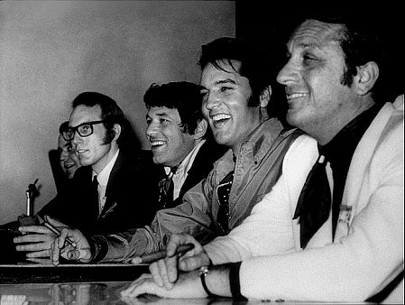 Elvis Presely, Bones Howe (director), Steve Binder (producer), and Bob Finkel (producer) at a press conference, 1968.