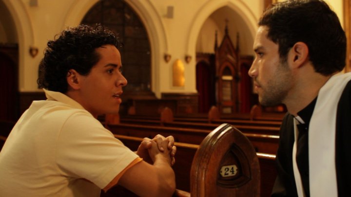 Fabio Costaprado (Elliot) and the priest (Justin Montoya) in Elliot Loves