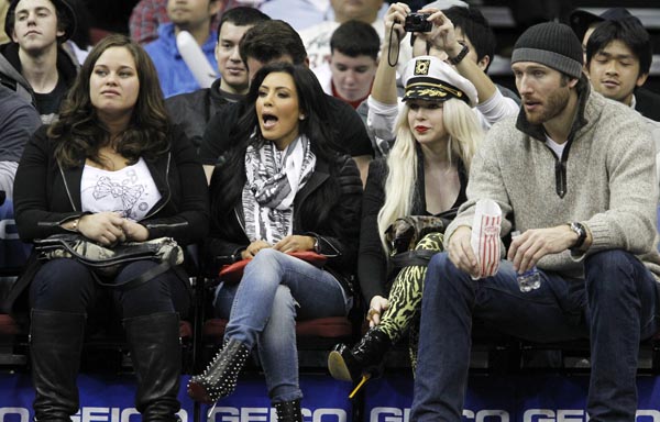 Kim Kardashian, her make-up artist Joyce Bonelli, and Peter Cornell courtside at the Prudential Center in New Jersey watching the Nets host the Pacers on February 6th, 2011